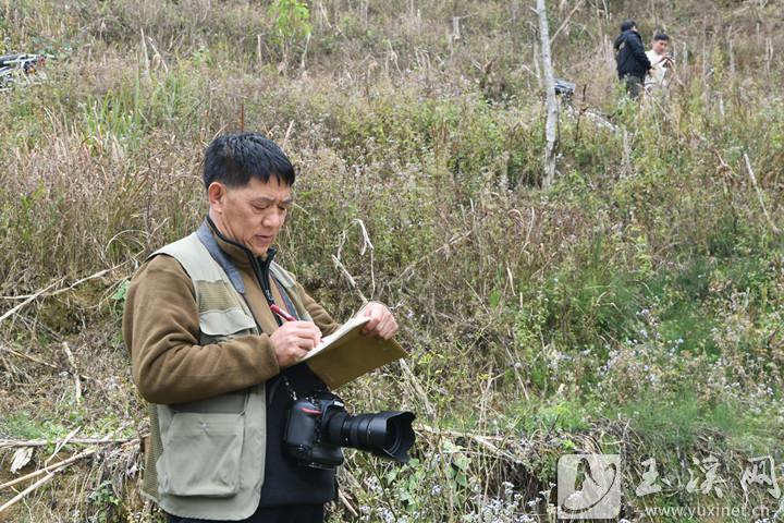 官朝弼在采访现场做记录。 本报记者崔永红摄于2024年2月11日。